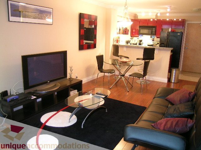 Spacious living room with modern furniture, hardwood floors, and a cozy sofa. - 603 - 1328 West Pender, Vancouver Downtown