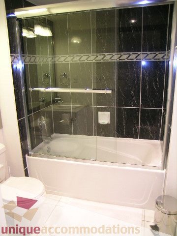 Spacious bathroom with modern glass shower and sleek white tub. - 603 - 1328 West Pender, Vancouver Downtown