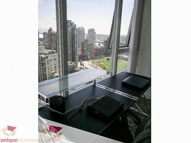 Furnished living room with city view and modern decor. - 2706 - 1438 Richards Street, Vancouver Downtown