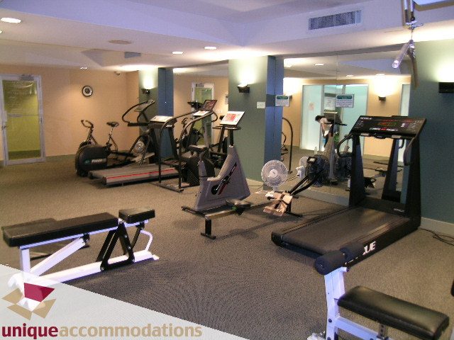 Spacious fitness room with cardio equipment and weight machines, perfect for workout enthusiasts. - 306 - 588 Broughton Street, Vancouver Downtown