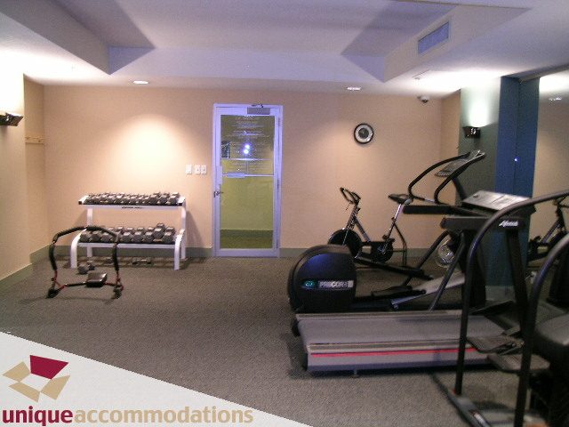 Spacious gym with treadmills, dumbbells, and exercise bikes, perfect for fitness enthusiasts. - 306 - 588 Broughton Street, Vancouver Downtown