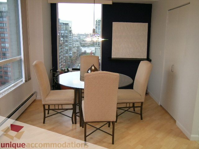 Spacious dining area with city view, hardwood floors, and modern furnishings. - 1306-388 Drake St, Vancouver Downtown