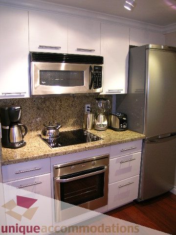 Bright kitchen with granite countertops, stainless steel appliances, and hardwood floors. - 905 - 1331 West Georgia Street, Vancouver Downtown