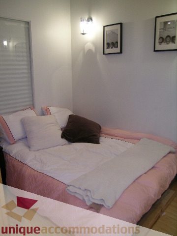 Furnished 1-bedroom + den with cozy bedding and wall art. - 503-1072 Hamilton St., Vancouver Downtown
