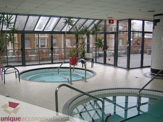 Bright sunlit patio with a hot tub and city view. - 1906 - 1060 Alberni Street, Vancouver Downtown