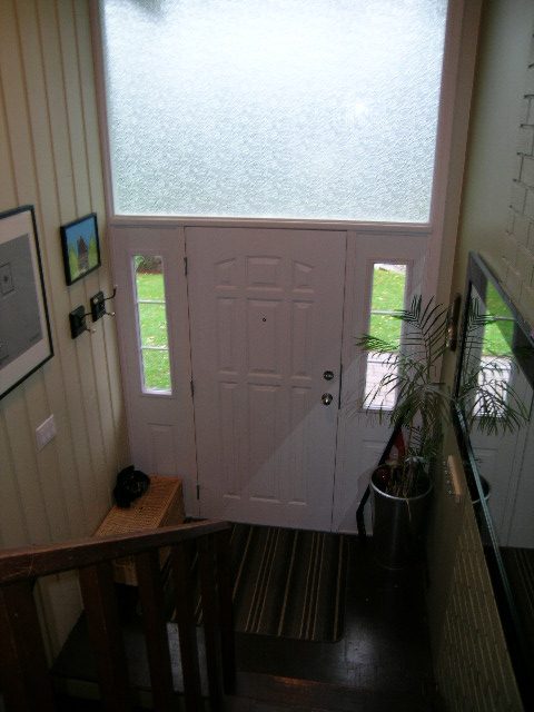 Staircase leading to front door with frosted glass window and potted plants. - 433 Fairway Drive, North Vancouver