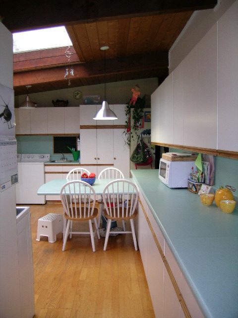 Bright kitchen with light blue countertops, hardwood floors, and a skylight. - 433 Fairway Drive, North Vancouver