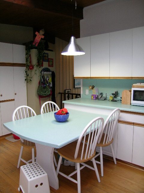 Bright kitchen with light blue countertops, white cabinets, and hardwood floors. - 433 Fairway Drive, North Vancouver