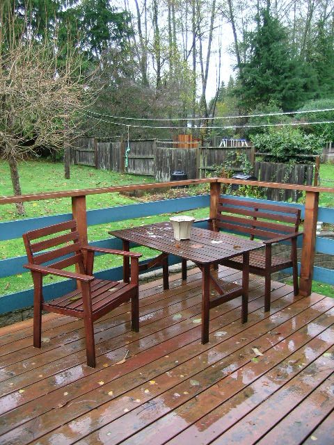 Cozy outdoor deck with wooden furniture and rain-soaked deck boards. - 433 Fairway Drive, North Vancouver