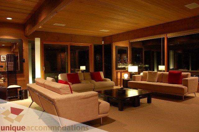 Spacious living room with large windows, cozy seating, and warm lighting. - 6290 Collingwood Street, Vancouver West Side