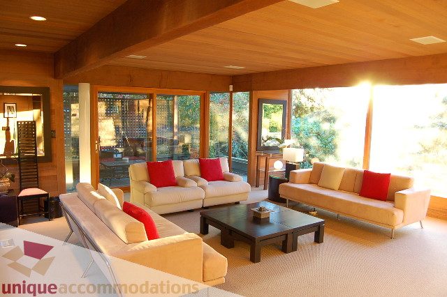 Spacious living room with large windows, natural light, and modern furniture. - 6290 Collingwood Street, Vancouver West Side