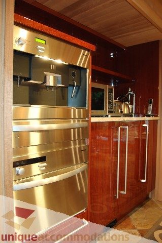 Bright kitchen with stainless steel appliances and wooden cabinetry. - 6290 Collingwood Street, Vancouver West Side