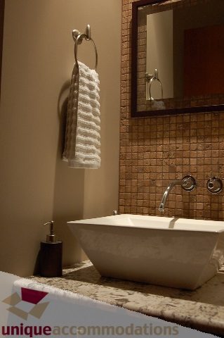 Furnished bathroom with a modern sink, mosaic tile backsplash, and granite countertop. - 6290 Collingwood Street, Vancouver West Side