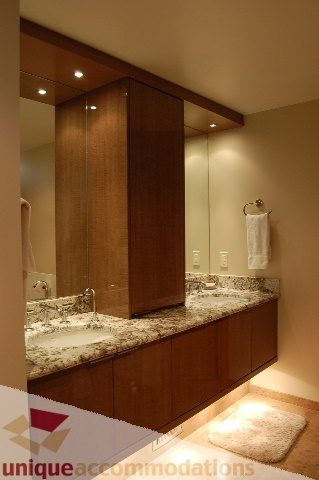 Furnished bathroom with granite countertops and wooden cabinets. - 6290 Collingwood Street, Vancouver West Side