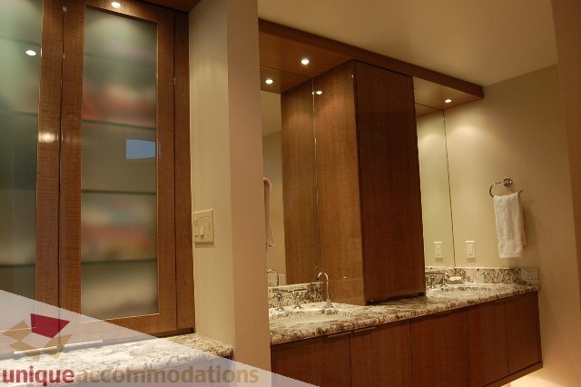 Furnished bathroom with modern vanity and large mirror. - 6290 Collingwood Street, Vancouver West Side
