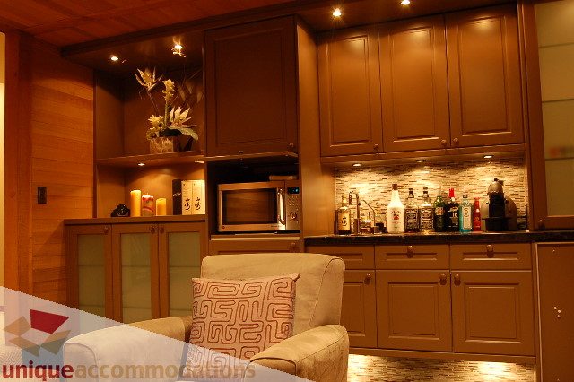 Bright kitchen with wooden cabinets, granite countertops, and a modern backsplash. - 6290 Collingwood Street, Vancouver West Side