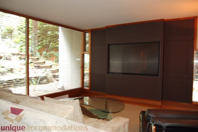 Living room with large windows, modern furniture, and a view of the garden. - 6290 Collingwood Street, Vancouver West Side