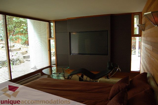 Living room with large windows, modern furniture, and a flat-screen TV. - 6290 Collingwood Street, Vancouver West Side