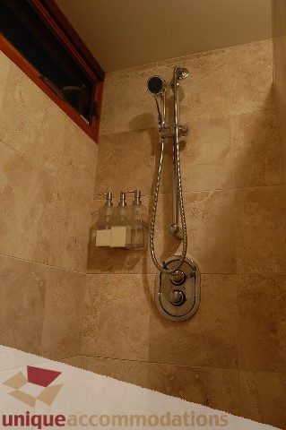 Bathroom with tiled walls and a modern shower setup. - 6290 Collingwood Street, Vancouver West Side