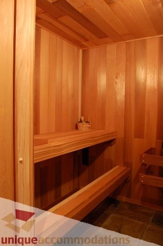 Spacious wooden sauna with bench seating and shelves. - 6290 Collingwood Street, Vancouver West Side