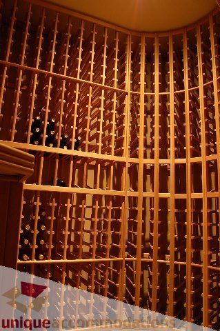 Wine cellar with wooden racks and bottles neatly stored. - 6290 Collingwood Street, Vancouver West Side