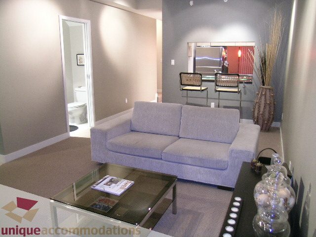 Furnished living room with modern furniture and a glass coffee table. - 1430 Strathmore Mews, Vancouver Downtown