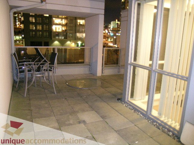 Furnished balcony with city view and outdoor seating. - 1430 Strathmore Mews, Vancouver Downtown