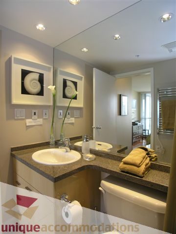 Spacious bathroom with granite countertops, modern sink, and stylish wall art. - 1008 - 1408 Strathmore Mews, Vancouver Downtown
