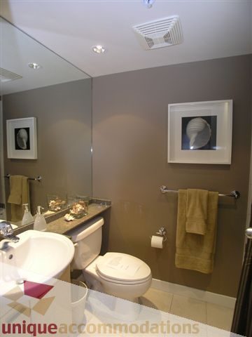 Spacious bathroom with modern sink, large mirror, and neatly arranged towels. - 1008 - 1408 Strathmore Mews, Vancouver Downtown