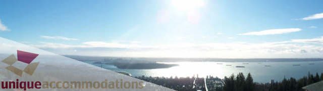 Furnished living room with a stunning city view and large windows. - 1659 Langton Place, West Vancouver