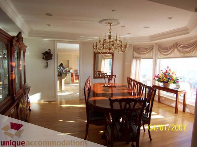 Elegant dining room with chandelier, hardwood floors, and large windows. - 1659 Langton Place, West Vancouver