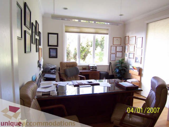 Furnished office with large windows, framed certificates, and a desk. - 1659 Langton Place, West Vancouver