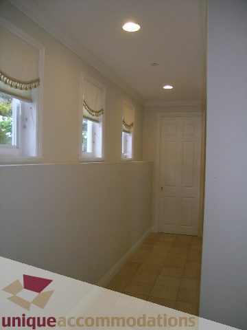 Bright kitchen with white cabinets and tiled floor. - 1659 Langton Place, West Vancouver