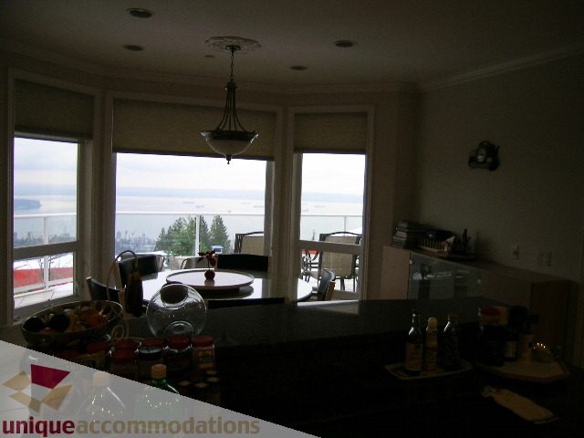 Bright kitchen with granite countertops and a stunning city view. - 1659 Langton Place, West Vancouver