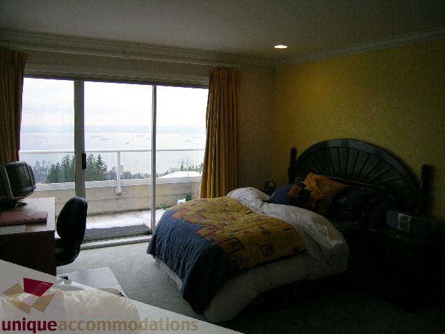 Spacious bedroom with a stunning ocean view and yellow walls. - 1659 Langton Place, West Vancouver