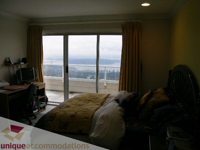 Spacious bedroom with large windows offering a stunning city view. - 1659 Langton Place, West Vancouver