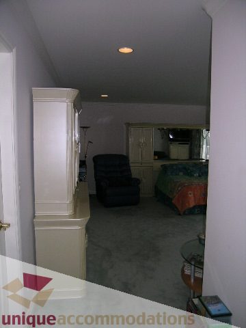 Living room with carpeted floor and glass coffee table. - 1659 Langton Place, West Vancouver