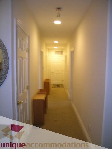 Furnished hallway with wooden bench and light fixture. - 1659 Langton Place, West Vancouver