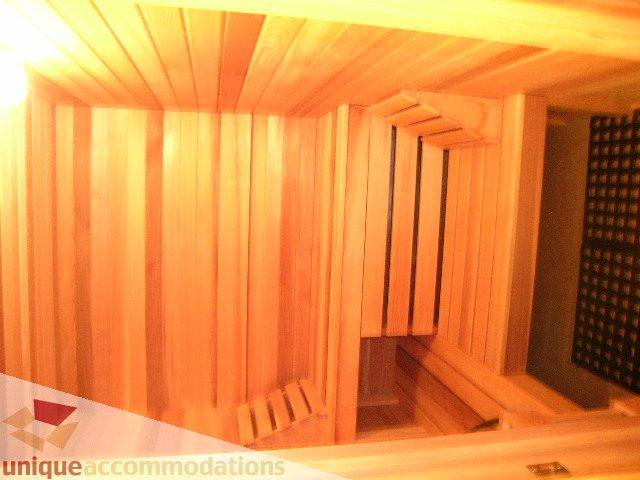 Cozy wooden sauna with bench seating and acoustic panels. - 1659 Langton Place, West Vancouver
