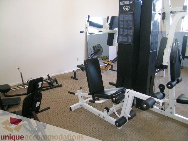 Bright gym with cardio and weight machines, carpeted floor. - 313-525 Wheelhouse Square, Vancouver West Side
