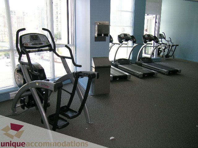 Bright gym with treadmills and city view windows. - 1135 Seymour Street, Vancouver Downtown