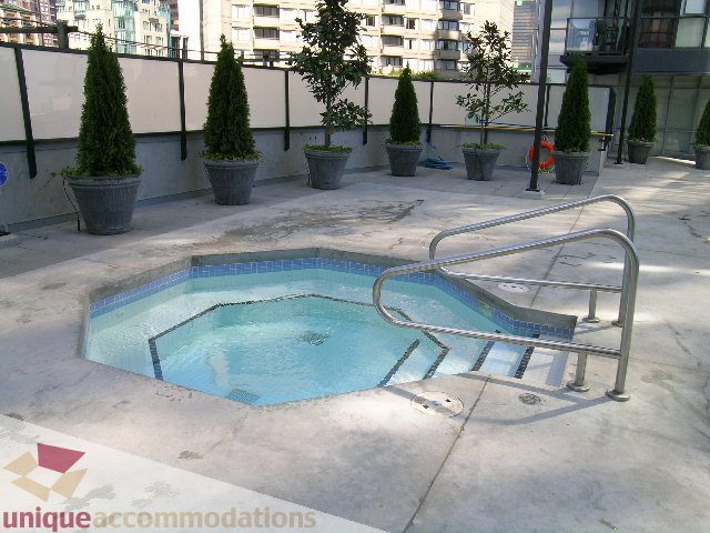 Furnished rooftop patio with a hot tub and potted trees. - 1135 Seymour Street, Vancouver Downtown