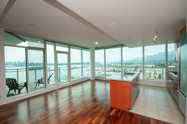 Spacious penthouse kitchen with hardwood floors, granite countertops, and stunning city views. - 2302 - 138 East Esplanade, North Vancouver