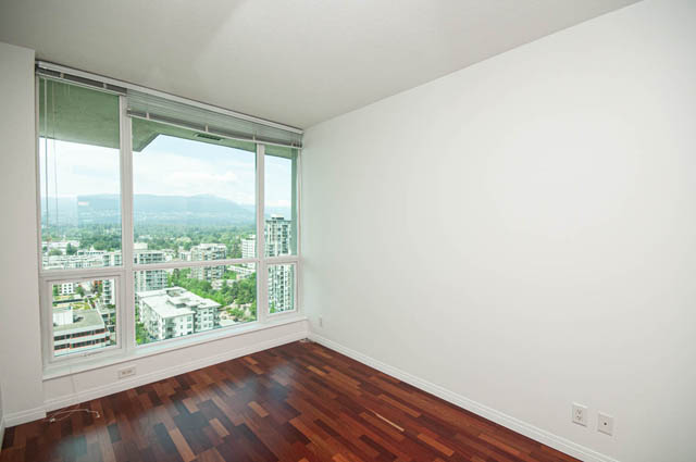 Spacious penthouse living room with hardwood floors and a stunning city view. - 2302 - 138 East Esplanade, North Vancouver