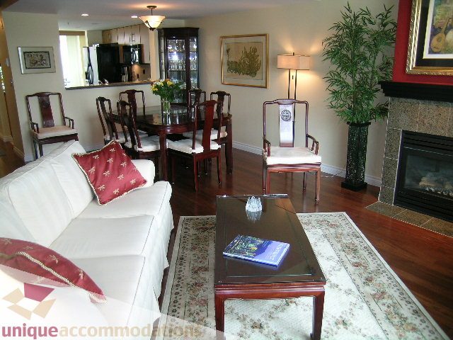 Furnished living room with hardwood floors, white couch, and wooden coffee table. - 305 - 1030 Quebec Street, Vancouver Downtown