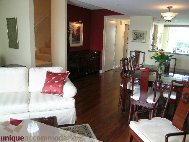 Furnished living room with white couch, hardwood floors, and dining area with wooden chairs. - 305 - 1030 Quebec Street, Vancouver Downtown