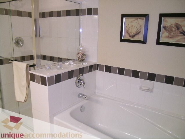 Furnished bathroom with a bathtub and a mirror above the sink. - 305 - 1030 Quebec Street, Vancouver Downtown