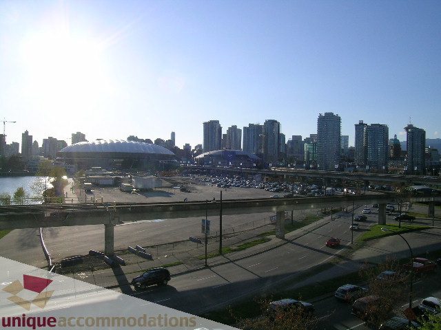 Furnished living room with city view and modern furnishings. - 305 - 1030 Quebec Street, Vancouver Downtown