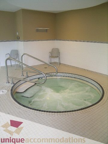 Jacuzzi with tiled edges and chairs for relaxation. - 305 - 1030 Quebec Street, Vancouver Downtown