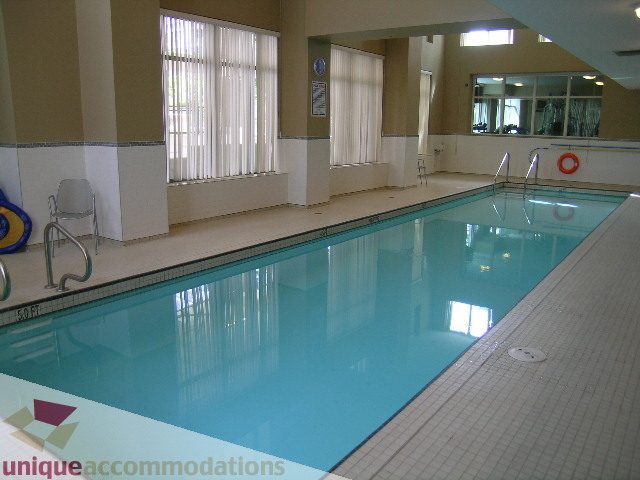 Spacious indoor pool with tiled edges and large windows. - 305 - 1030 Quebec Street, Vancouver Downtown